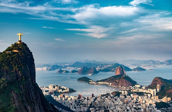 Aerial view of Rio De Janeiro. Corcovado mountain with statue of Christ the Redeemer, urban areas of Botafogo and Centro, Sugarloaf mountain.