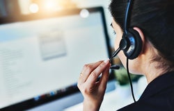 Rearview shot of a young woman working in a call centre