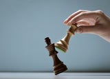 Player defeating the king and winning a chess game, strategy and tactics concept