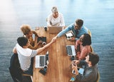 Handshake, above and business people in a meeting for a deal, onboarding and welcome. Happy, interview and corporate employees shaking hands for thank you, support or partnership in group discussion