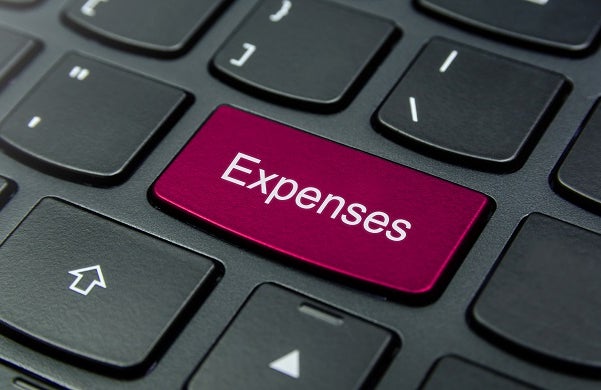 Close-up of a keyboard with an Expenses button in red.