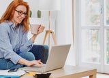 Young woman using notebook and working at home