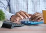 Person using a calculator at a desk