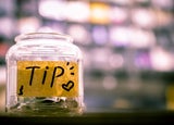 Tip jar containing cash