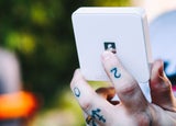 An image of a man holding a SumUp card reader