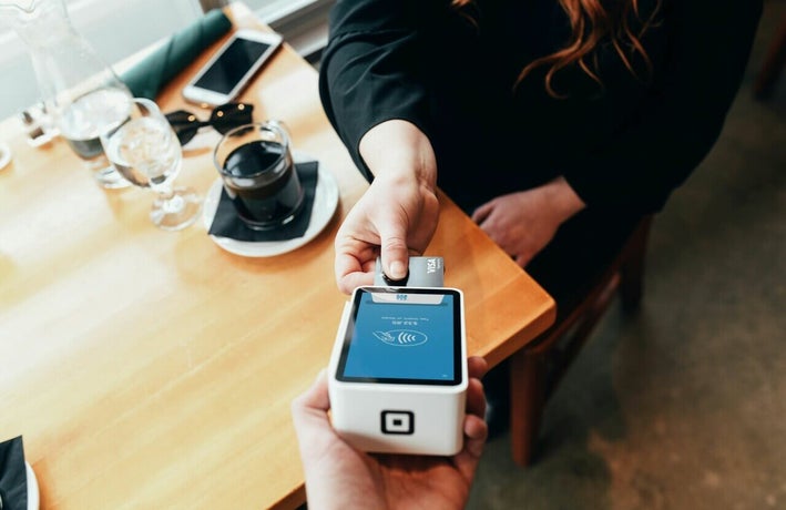 Customer paying by card at a cafe