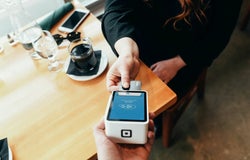 Customer paying by card at a cafe