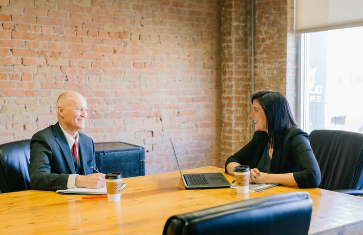 Two coworkers having a meeting in a meeting room