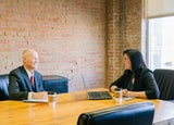 Two coworkers having a meeting in a meeting room