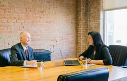 Two coworkers having a meeting in a meeting room