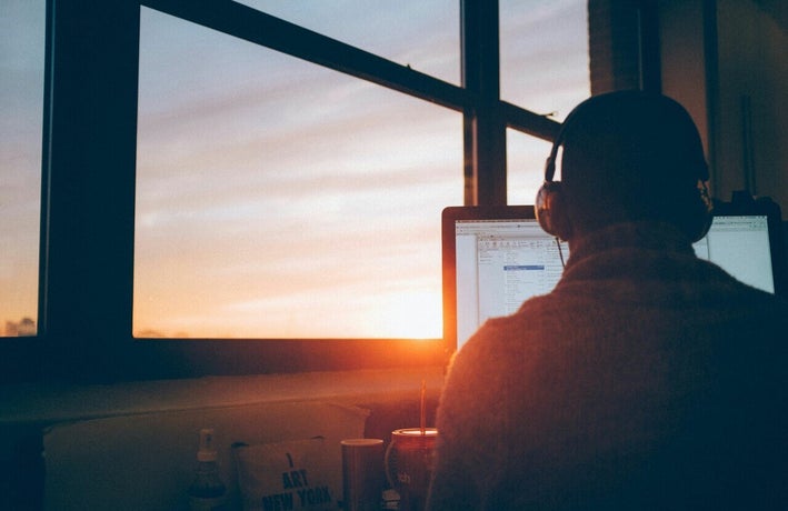 Employee working at a computer at sunset