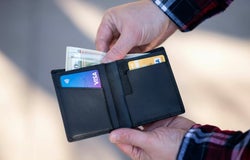 Person taking cash out of a wallet