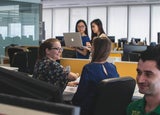 Employees chatting in a shared office space