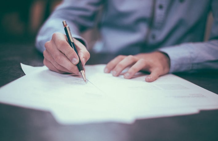 a man writing on paper