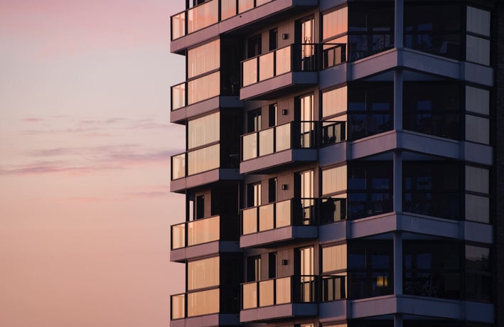 A close-up image of a block of flats at sunset