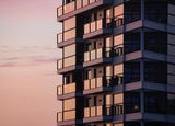 A close-up image of a block of flats at sunset