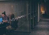 two men working in a dark office