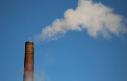 industrial pipe spewing CO2 into atmosphere