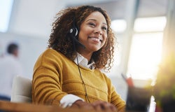 woman, call center agent or smile with voip for consulting, listening or contact us in office. Female consultant, customer service or tech support crm with headphones, microphone or help desk