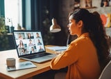 Back view of female employee talking on video call with colleagues. Working from home concept. Generative AI