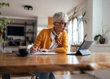 Senior businesswoman, working hard, from home office.