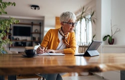 Senior businesswoman, working hard, from home office.