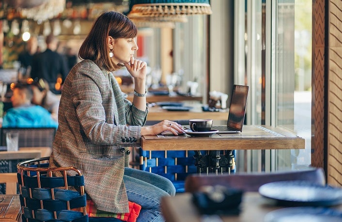 freelancer woman working remotely in cafe