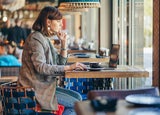 freelancer woman working remotely in cafe