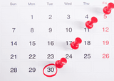 Dates marked on a calendar with pins